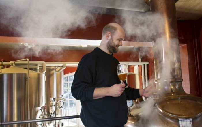 Prague Microbrewery with man Checking brew