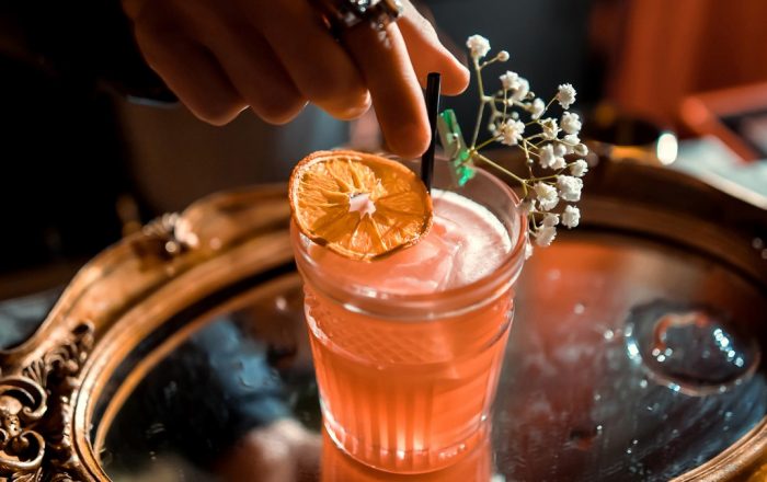 Garnishing cocktail with flowers